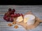 Soft blue cheese, ripe red grapes and walnuts on natural burlap backdrop