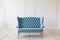 Soft blue sofa near white wall.