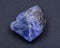 Soft blue violet rough TANZANITE from Tanzania isolated on black