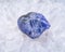 Soft blue violet rough TANZANITE from Tanzania placed on a crystalline druzy center of Polished Large Natural Blue Lace Agate