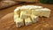 Soft brie cheese cubes on rustic board