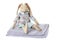 Soft bunny toy sitting on textile napkin over white