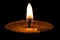 Soft candle light over black blurred background, inspirational peace mood