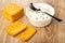 Soft cheese with dill in white jar, spoon, crackers on wooden table