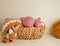 Soft coloured woolen balls with granny square blanket in basket