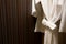 Soft comfortable bathrobes hanging on rack in closet