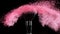 Soft cosmetics brush releasing a cloud of pink face powder