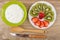 Soft cottage cheese in bowl, slices of kiwi and strawberry