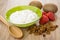 Soft cottage cheese in green bowl, kiwi, strawberry, raisin