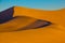 The soft curves of orange sand dunes