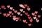 Soft defocused bokeh background with pink hearts, light from garland with open camera aperture, valentine`s day background