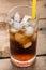 Soft drinks, Cola glass with ice cubes on a wood background.