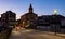 Soft evening light of lanterns illuminates narrow stone bridges of town Cenicero