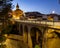 Soft evening light of lanterns illuminates narrow stone bridges of town Cenicero