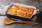 Soft and Fluffy Butter Swim Biscuits baked in baking dish of melted butter closeup. Horizontal