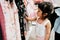 Soft Focus of a 4-5 Years Old Child Choosing her own Dresses from Kids Cloth Rack in Clothing Shop