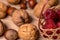 Soft focus, blurring background. Hazelnuts and walnuts. Raspberry wicker basket. Macro.