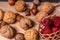 Soft focus, blurring background. Hazelnuts and walnuts. Raspberry wicker basket. Macro.