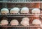 Soft focus chinese pork bun or steamed dumpling in steam cabinet warming for sale ready to eat in mini mart , Chinese food