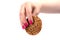 Soft focus. Female hand with a manicure holds oatmeal cookies with cereals over white background