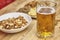 Soft focus of a glass of a foamy craft beer with blurry food in the background on a wooden table