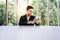 Soft Focus of Happy Young Businessman Working on Tablet at the Table in Office by Glass Window