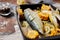 Soft focus marinated mackerel with vegetables. Saltwater fish with spices and vegetables in a cast iron baking dish on a rustic