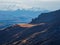 Soft focus. Mountains in a dense fog and sunny slope. Mystical landscape with beautiful sharp rocks in low clouds. Beautiful