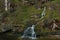 Soft focus nature spring time landscape highland green grass meadow with river stream and stump scenic view