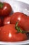 Soft focus of newly picked and washed fresh ripe juicy tomatoes with water droplets