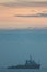 Soft focus painterly image of a boat at dawn in front of a beaut