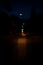 Soft focus paved road of night street car route abstract moody urban outdoor vertical picture view with lantern lights and nobody