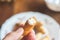 Soft focus of a person holding a half eaten breaded cheese on a blurry background