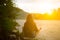 Soft focus photo. Girl is doing yoga in mountains. Wanderlust and freedom. Beautiful sunset. Woman in harmony on the river bank.