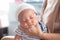 The Soft focus photo of mother, mom using hand Hold baby to help a baby newborn infant belch burping after breastfeeding milk to