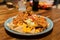 Soft focus of a serving of tasty nachos on a wooden table