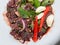 Soft focus of Spicy raw beef salad with chilli, garlic and mint