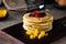 Soft focus of a stack of fluffy pancakes with fresh fruits on a wooden board