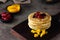 Soft focus of a stack of fluffy pancakes with fresh fruits on a wooden board