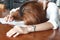 Soft focus of tired exhausted young business woman bend down head on the workplace in office.