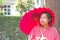 Soft focus on Traditional Japanese Yukata young girl with red umbrella in garden, Asian girl in Yukata with umbrella