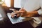 Soft focus of woman hand working with phone on desk in coffee shop. Vintage tone.