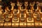 Soft focus of wooden chess pieces on a board at the start of a game.