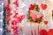 Soft focused shot of Valentine`s day decorative elements, festive romantic wreath and wooden hearts garland