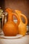Soft focused wine jugs of terracotta color on the table, simple
