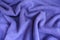 Soft folds on violet woolen jersey fabric