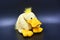 Soft funny toy, curly yellow duck located on a black background.