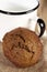 Soft ginger cookie with milk in white enamel mug