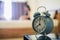 Soft light and Blurred image, alarm clock placed next to bed woke up at set time for woman to wake up and prepare to leave for