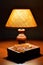 Soft light of table lamp, old book prayer book or Bible and amber Catholic rosary on table. Religion, evening prayer. Religion